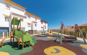 a playground with a slide and swings at Villa Godoy in Periana