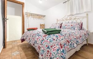 a bedroom with a bed with a colorful comforter at Villa Godoy in Periana +26 photos