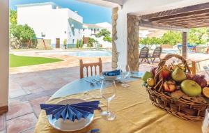 a table with a basket of fruit and wine glasses at Villa Godoy in Periana