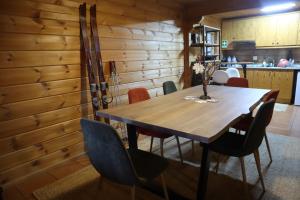 a dining room with a wooden table and chairs at Chalet Belfort in Penhas da Saúde