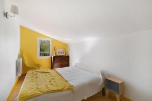 a bedroom with a bed and a dresser and a window at Gite De Marlas in Rieucros