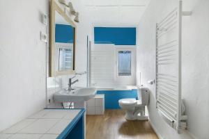 a bathroom with a white sink and a toilet at Gite De Marlas in Rieucros