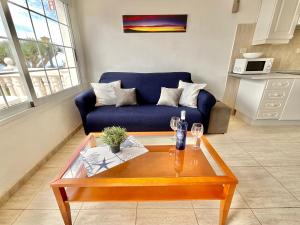 a living room with a blue couch and a coffee table at Atlantic Ocean Rest in Tacoronte +15 photos