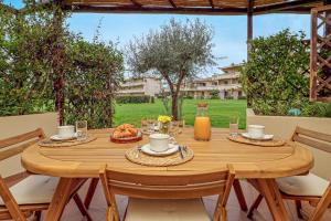 a wooden table with food on it on a patio at Casa Dina - by And Service in Golfo Aranci