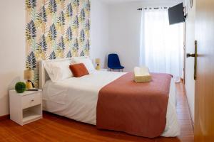 a bedroom with a bed and a window at Central Square in Povoação