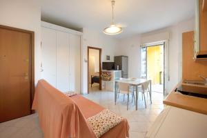 a kitchen and living room with a table and a room at Trilocale Mazzini con 2 balconi in Varazze