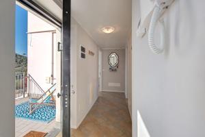 a hallway with a door leading to a balcony at Casa Marincanto in Varazze +21 photos