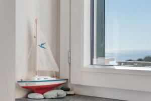 a toy boat sitting next to a window at Casa Marincanto in Varazze