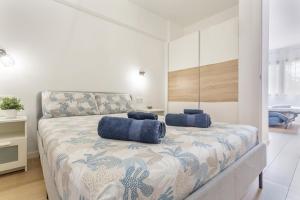 a bedroom with a bed with blue pillows on it at Playa De Las Américas - Oceanfront in Costa de Adeje