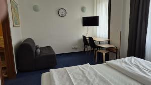 a hotel room with a bed and a chair and a table at Apartmán C311 in Frymburk