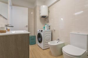 a bathroom with a washing machine and a washer at Playa De Las Américas - Oceanfront in Costa de Adeje +19 photos