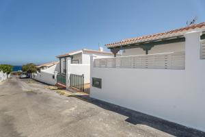 a row of white houses on a street at Bonita Casa Annie in Abades