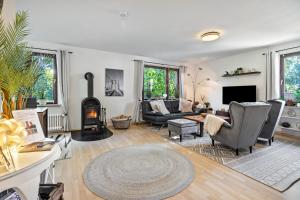a living room with a couch and a fireplace at Gästehaus Oehm in Faßberg