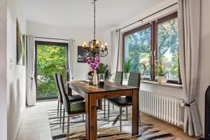 a dining room with a wooden table and chairs at Gästehaus Oehm in Faßberg