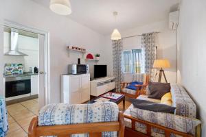 a living room with a couch and a table at Beautiful Traditional House in Chipiona