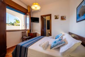 a bedroom with a bed and a window at By The Sea – Le Chele in Torre Lapillo