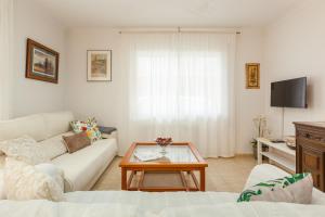 a living room with a couch and a coffee table at Amelie Apartment in Canet de Mar