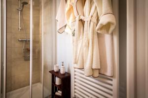 a bathroom with a shower and towels hanging on a wall at Appartamento Panoramico Como in Blevio +20 photos