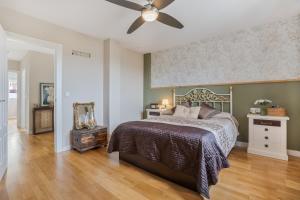 a bedroom with a bed and a ceiling fan at Villavillanos in Otura +30 photos