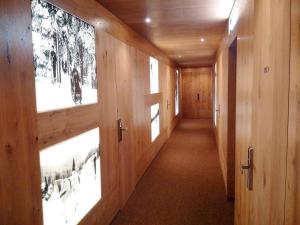 a hallway with wooden walls with pictures on the walls at Apartment Katrin Harrachov Resident - Sauna world free in Harrachov