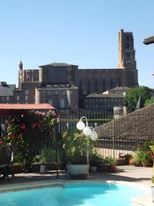 a swimming pool with a view of the city at La Chambre de Cécile in Albi +6 photos
