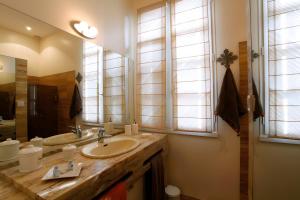a bathroom with two sinks and a large mirror at La Chambre de Cécile in Albi