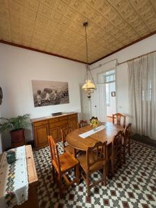 a dining room with a wooden table and chairs at Casa Antigua Arona in Arona