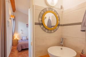 a bathroom with a sink and a mirror on the wall at Perles De Aime in Laurac-en-Vivarais