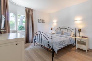 a bedroom with a bed and a window at Casa Viviana in Moraira +23 photos
