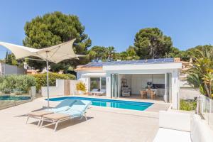 a villa with a swimming pool and a house at Casa Viviana in Moraira