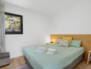 a bedroom with a bed with two towels on it at Casa Dona Florinda in Ermida +45 photos