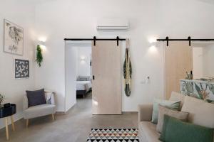 a living room with a sliding door leading to a bedroom at Moncoração Village in Moncarapacho