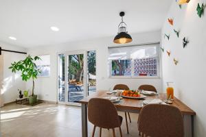 a dining room with a wooden table and chairs at Moncoração Village in Moncarapacho