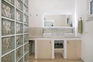 a bathroom with two sinks and a mirror at Moncoração Village in Moncarapacho +23 photos