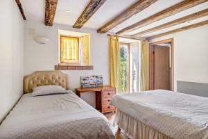 a bedroom with two beds and a mirror at Gîtes Bourdeverre in Sanxay +45 photos