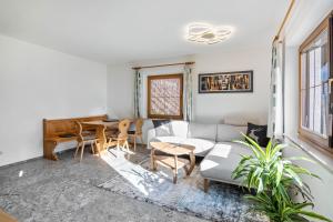 a living room with a couch and a table at Pixnerhof - Ferienwohnung Golden in Kastelbell-Tschars