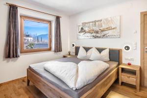 a bedroom with a bed and a window at Pixnerhof - Ferienwohnung Golden in Kastelbell-Tschars