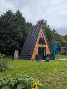 a small house with a dog sitting in front of it at Le petit Sabotier in Soucht +11 photos