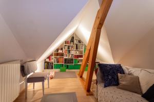 a living room with a couch and a book shelf at Chambre d'hotes à Laroin in Laroin