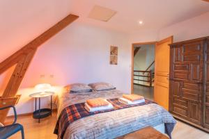 a bedroom with a bed with two pillows on it at Chambre d'hotes à Laroin in Laroin