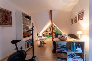 a living room with a staircase and a room with a chair at Chambre d'hotes à Laroin in Laroin +12 photos