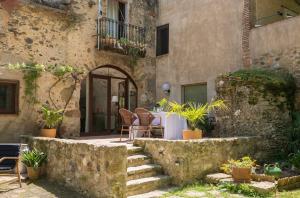 a patio with a table and chairs in a building at Can Bonet - la Volta in Sant Martí Vell