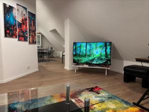a living room with a large flat screen tv at Good Habits in Kleinengstingen