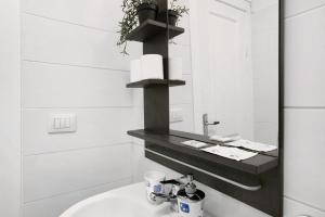 a white bathroom with a sink and a mirror at Loft Guanapay 1 in Arona
