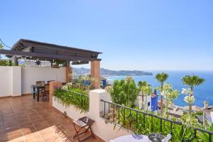 a balcony with a view of the ocean at Stunning sea views pool garden in La Herradura