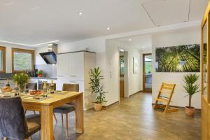 a kitchen and dining room with a table and chairs at Ferienhaus Hensler in Hinterzarten