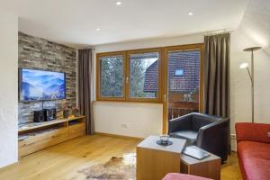 a living room with a couch and a tv at Ferienhaus Hensler in Hinterzarten