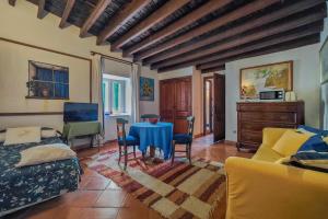 a living room with a blue table and chairs at Navila Pasillo Superior in Ibiza Town +14 photos