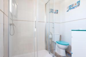 a bathroom with a shower and a toilet at Casa Capricho in Vejer de la Frontera +24 photos