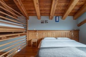 a bedroom with a bed and wooden ceilings at Civico 8 in Marmora